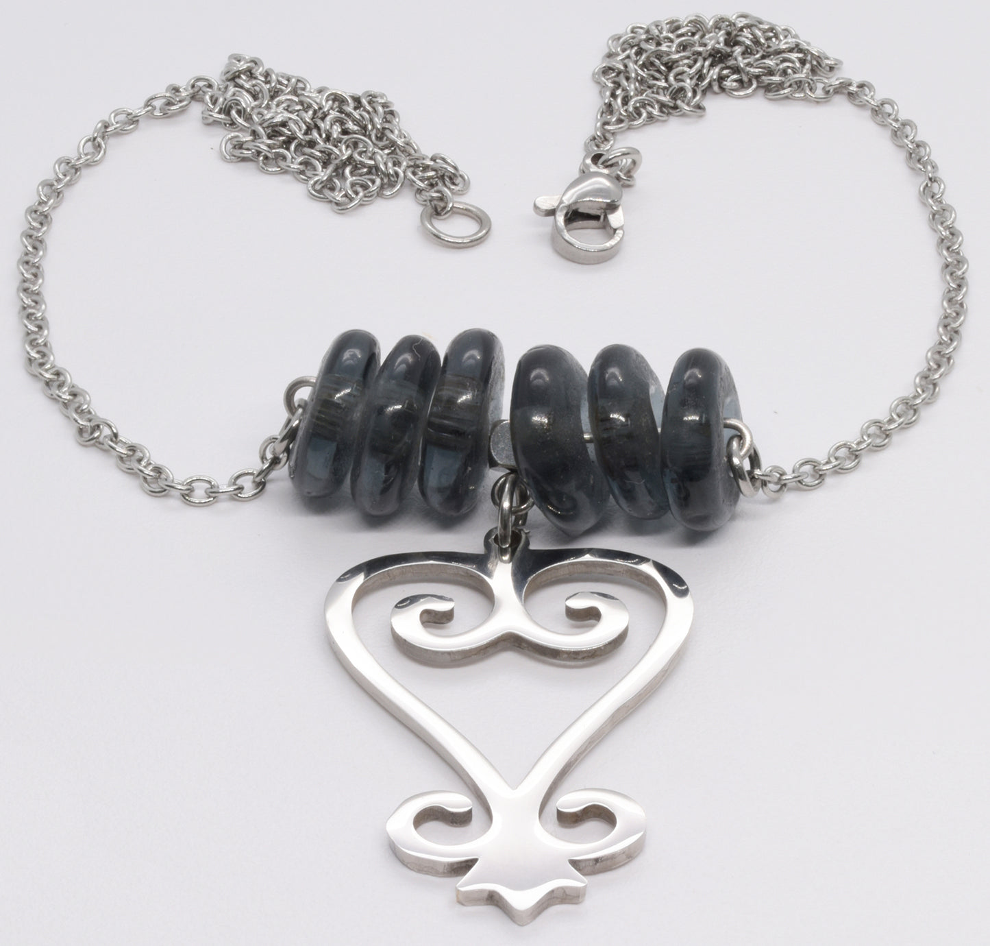 Handmade African Earrings & Pendant With Smoke Gray Beads & Adinkra Sankofa Symbol - angled shot